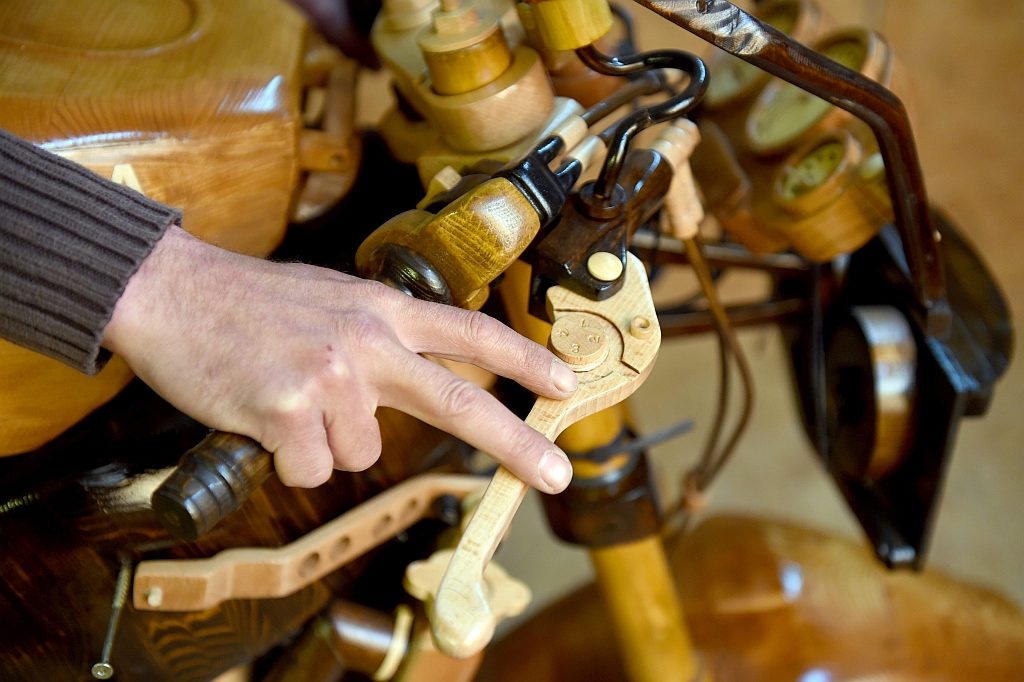 epa04745579 A picture made available on 13 May 2015 shows carefully-crafted details on Andre Schlosser's wooden motorbike, which he has been building for the last twelve years, in his garage in Nienborstel, Germany, 30 April 2015. Because his wife did not want him to put his old Yamaha motorbike in the living room, he made a copy of the Yamaha FZR 600 from wood.  EPA/CARSTEN REHDER