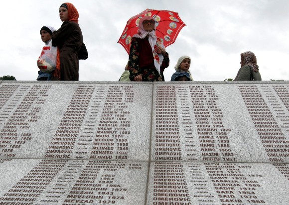 epa04766960 (FILE) A file picture dated 11 July 2009 shows visitors reading the names of Bosnian Muslims who were killed in the 1995 Srebrenica massacre on a memorial plaque at the cemetery where 534 newly-identified Bosnian Muslims were to be buried, Bosnia and Herzegovina. July 2015 marks the 20-year anniversary of the Srebrenica Massacre that saw more than 8,000 Bosniak men and boys killed by Bosnian Serb forces during the Bosnian war.  EPA/FEHIM DEMIR PLEASE REFER TO THIS ADVISORY NOTICE (epa04766937) FOR FULL PACKAGE TEXT
