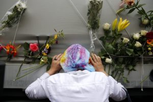 epa04838257 A Bosnian woman pays her respects to the remains of 136 identified Bosnian Muslims ahead of the burial ceremony in Sarajevo, Bosnia and Herzegovina, 09 July 2015. July 2015 marks the 20-year anniversary of the Srebrenica Massacre that saw more than 8,000 Bosnians men and boys killed by Bosnian Serb forces during the Bosnian war.  EPA/VALDRIN XHEMAJ