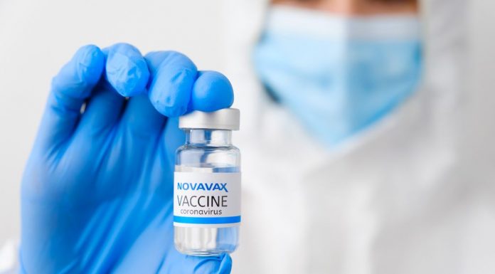 Novavax coronavirus vaccine in doctors or nurses hands in blue rubber gloves. Prevention of sars-cov-2 or Covid-19, January 2021, San Francisco, USA